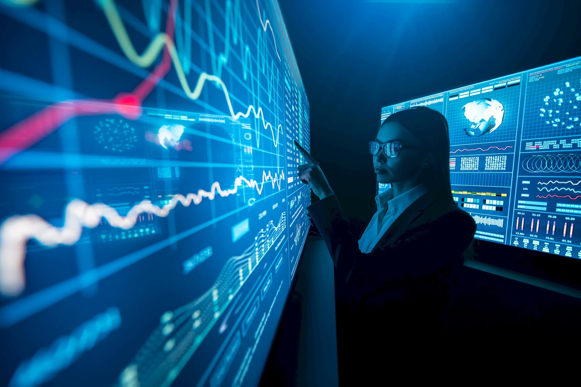 An analyst reading search and performance dashboards on a wall of screens